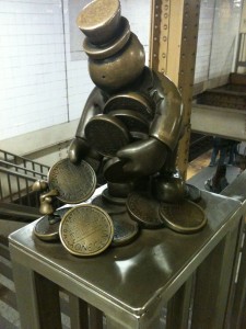 bronze man with coins